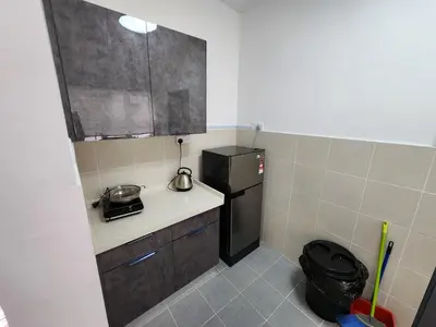 a small kitchen with a refrigerator and a sink at Sweet Home G12 Emerald Avenue in Brinchang