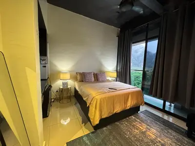a bedroom with a bed and a large window at D'Royale NH Homestay Kompleks Mutiara Gua Musang in Gua Musang