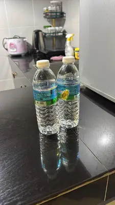 two bottles of water sitting on top of a counter at D'Royale NH Homestay Kompleks Mutiara Gua Musang in Gua Musang