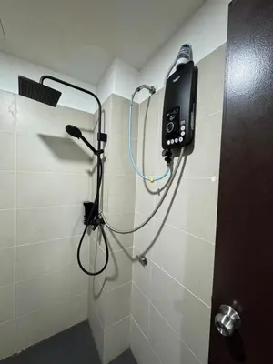 a shower in a bathroom with a phone on the wall at D'Royale NH Homestay Kompleks Mutiara Gua Musang in Gua Musang