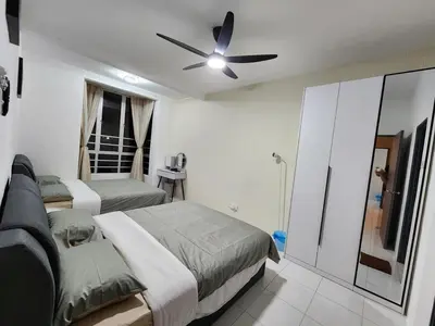 a bedroom with two beds and a ceiling fan at 6-17 Galaxy Styles Emerald Aveneu in Brinchang