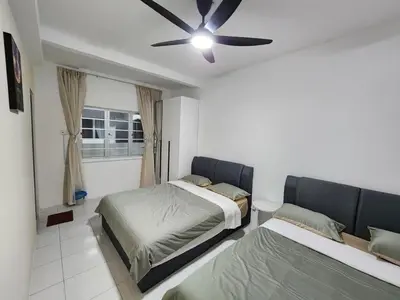 a bedroom with two beds and a ceiling fan at 6-17 Galaxy Styles Emerald Aveneu in Brinchang