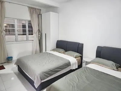 a bedroom with two beds and a window at 6-17 Galaxy Styles Emerald Aveneu in Brinchang