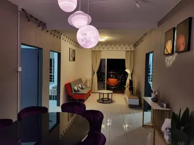 a living room with a table and chairs at 6-17 Galaxy Styles Emerald Aveneu in Brinchang