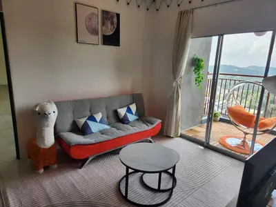a living room with a couch and a balcony at 6-17 Galaxy Styles Emerald Aveneu in Brinchang