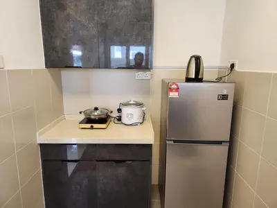 a small kitchen with a stainless steel refrigerator at 8-28 The Art Gallery Emeral Avenue in Brinchang
