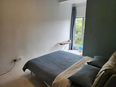 a bedroom with a bed in a room with a window at 8-28 The Art Gallery Emeral Avenue in Brinchang