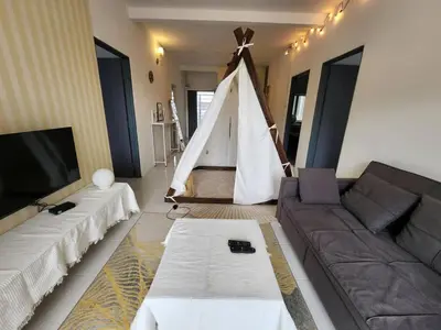 a living room with a couch and a net at 821 Camping Style in Brinchang