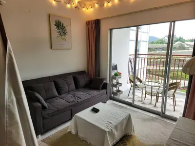 a living room with a couch and a balcony at 821 Camping Style in Brinchang