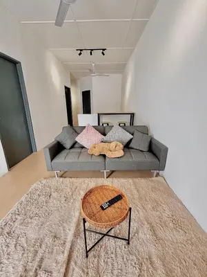a living room with a couch and a table at Cozyindah11A#7pax#netflix#NearAeonAlma#BukitMertajam in Bukit Mertajam
