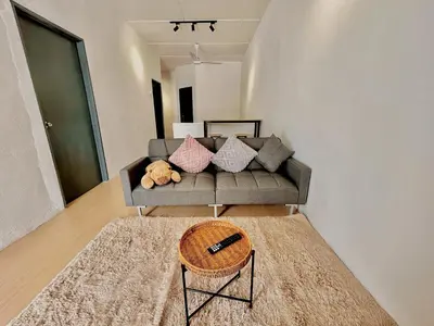 a living room with a couch with pillows on it at Cozyindah11A#7pax#netflix#NearAeonAlma#BukitMertajam in Bukit Mertajam