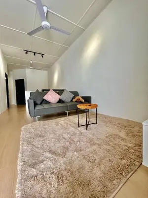 a living room with a couch and a table at Cozyindah11A#7pax#netflix#NearAeonAlma#BukitMertajam in Bukit Mertajam