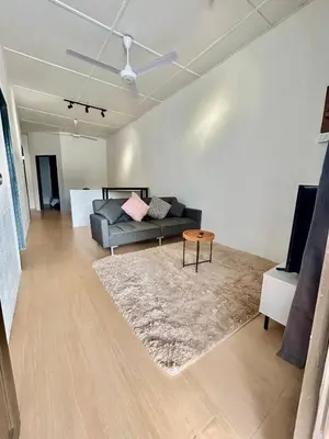 a living room with a couch and a table at Cozyindah11A#7pax#netflix#NearAeonAlma#BukitMertajam in Bukit Mertajam