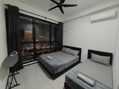 a bedroom with two beds and a window with a city skyline at Urban Suites Penang by Dynaz Homestay in Jelutong