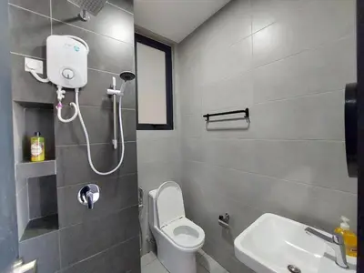 a bathroom with a shower and a toilet and a sink at Urban Suites Penang by Dynaz Homestay in Jelutong