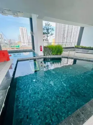 a large swimming pool with blue water in a building at Urban Suites Penang by Dynaz Homestay in Jelutong