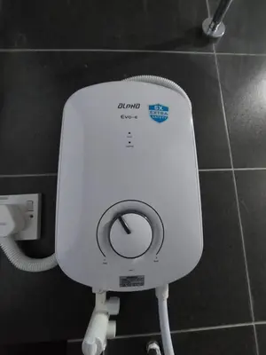 a toilet in a bathroom with a white tank at Urban Suites Penang by Dynaz Homestay in Jelutong