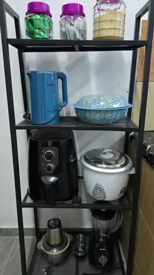 a shelf with a blender and other items on it at Azura Homestay Seri Iskandar in Seri Iskandar