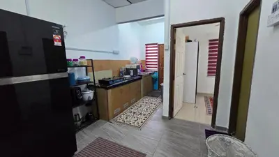 a room with a kitchen with a counter and a door at Azura Homestay Seri Iskandar in Seri Iskandar
