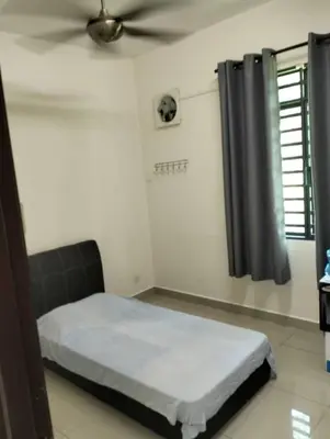 a bedroom with a bed and a ceiling fan at Adeline's Homestay Balik Pulau in Balik Pulau
