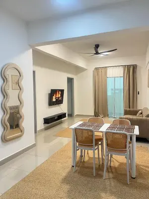 a living room with a table and chairs and a couch at M Retreat Cameron Highlands in Tanah Rata