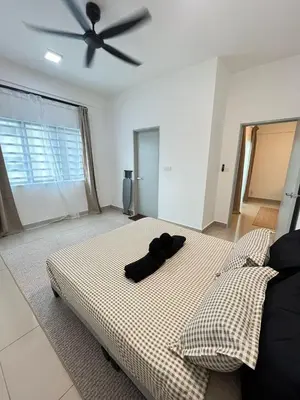 a bedroom with a large bed with a ceiling fan at M Retreat Cameron Highlands in Tanah Rata