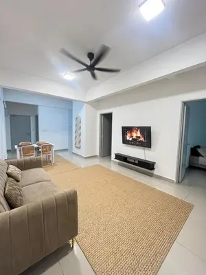 a living room with a couch and a fireplace at M Retreat Cameron Highlands in Tanah Rata