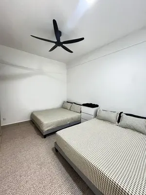 a bedroom with two beds and a ceiling fan at M Retreat Cameron Highlands in Tanah Rata