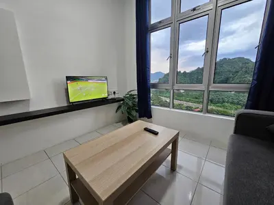 a living room with a tv and a coffee table at Ipoh Anderson Condo - 2BR in Ipoh
