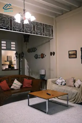 a living room with a couch and a coffee table at City-Center Heritage Getaway for 12 Pax in George Town