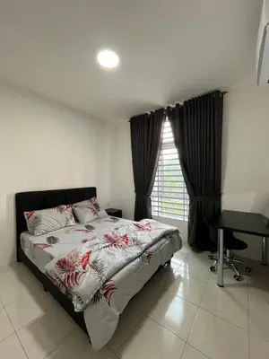 a bedroom with a bed and a desk and a window at Ipoh Condo Anderson residence in Ipoh