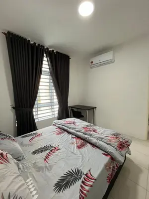 a bedroom with a bed with a comforter on it at Ipoh Condo Anderson residence in Ipoh