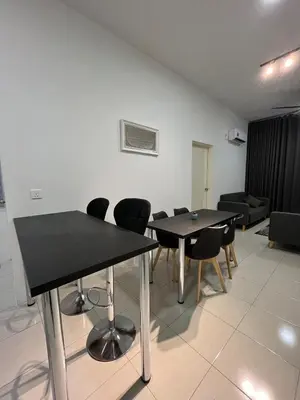 a room with two tables and chairs and a couch at Ipoh Condo Anderson residence in Ipoh