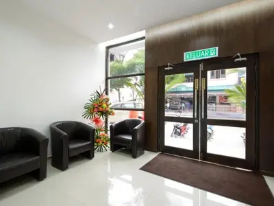 a lobby with chairs and a sign on the door at Swing & Pillows - Grand Inn George Town Penang in George Town