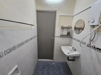 a white bathroom with a sink and a mirror at Pera House Hostel in Ipoh