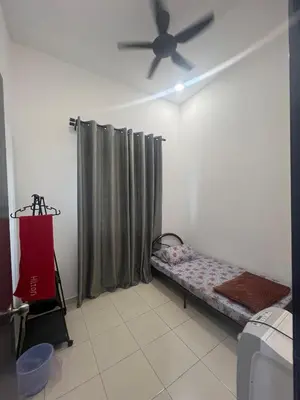 a room with a bed and a ceiling fan at Hasya Guesthouse in Seri Iskandar