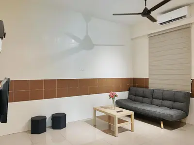 a living room with a couch and a table at Cozy Suite with Twin Beds & Lounge in Nibung Tebal