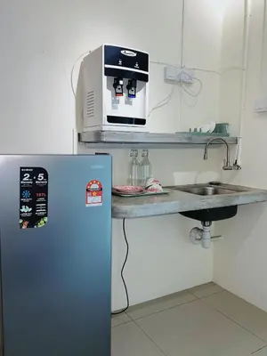 a kitchen with a refrigerator and a microwave at Cozy Suite with Twin Beds & Lounge in Nibung Tebal