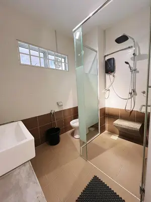 a bathroom with a shower and a toilet at Cozy Family Room with Large Balcony in Nibung Tebal