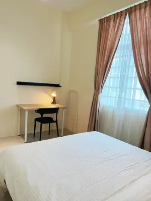 a bedroom with a bed and a desk and a window at Cozy 2-Bedroom Balcony Suite with Living Room in Nibung Tebal