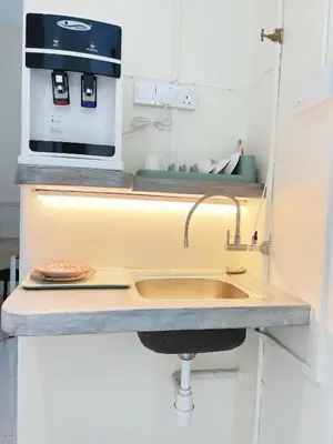 a kitchen with a sink and a microwave at Cozy 2-Bedroom Balcony Suite with Living Room in Nibung Tebal