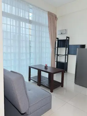 a living room with a couch and a table and a chair at Cozy 2-Bedroom Balcony Suite with Living Room in Nibung Tebal