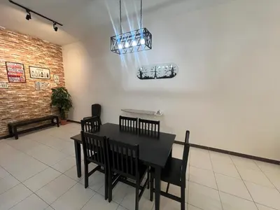 a dining room with a black table and chairs at StayIndah Homestay Cameron Highlands in Tanah Rata