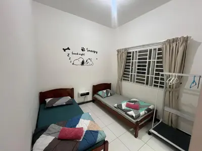 a room with two twin beds and a window at StayIndah Homestay Cameron Highlands in Tanah Rata