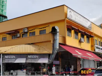 a yellow building on a street with people in front at SS2 Landed in Petaling Jaya for 8 Pax in Gua Sai