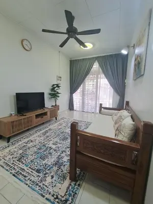 a living room with a bed and a flat screen tv at Wareesha Homestay, Corner Lot With Netflix in Padang Serai
