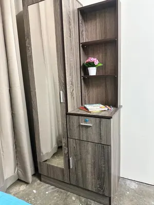 a wooden cabinet with a mirror in a room at Little Stay Inn in Taiping