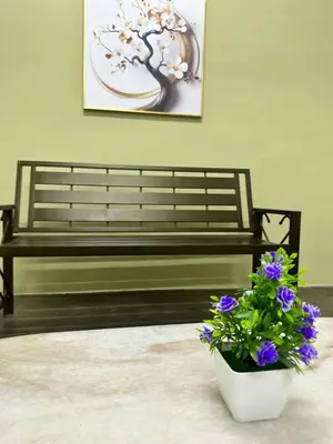 a bench with a flower pot and a plant at Little Stay Inn in Taiping