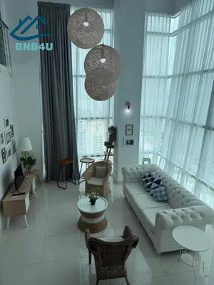 a living room with a couch and chairs and windows at Duplex Comfort Stay in George Town in George Town