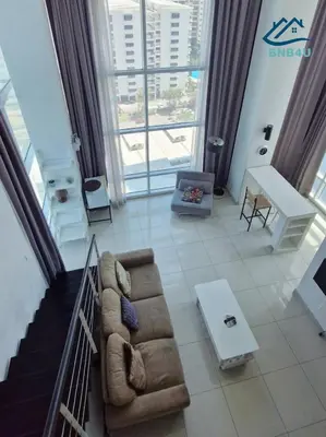 a living room with a couch and a large window at Duplex Comfort Stay in George Town in George Town
